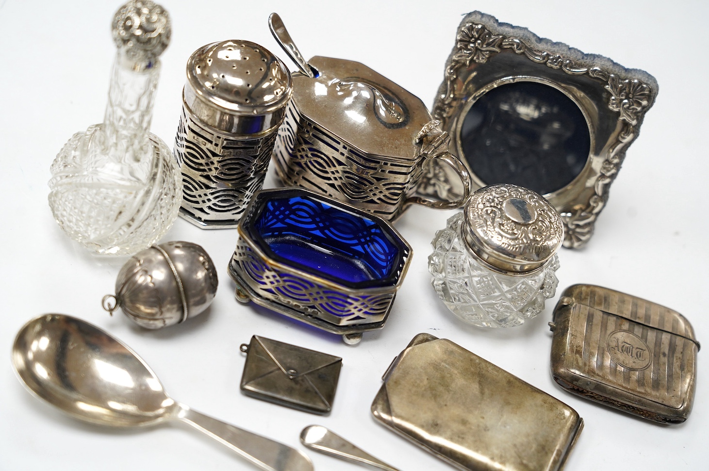 Sundry small silver etc., including condiments, toilet jars, vesta case, sterling envelope stamp case, plated match sleeve and silver caddy spoon. Condition - poor to fair